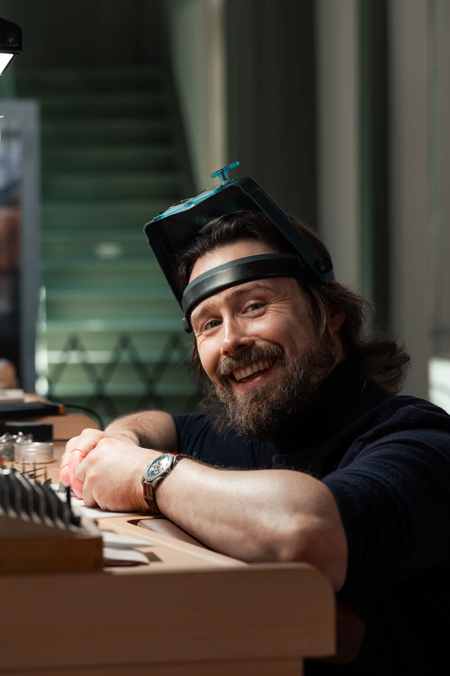 Michiel Holthinrichs smiling at his workbench in the Delft atelier